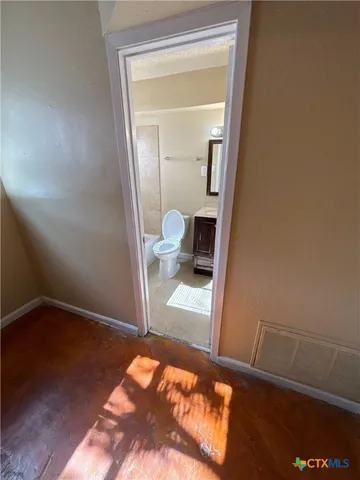 a view of a hallway and a livingroom with furniture