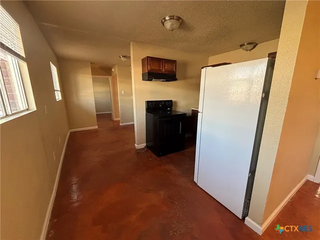 a view of a livingroom with a refrigerator