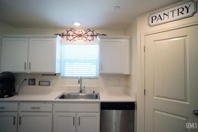 a kitchen with a sink cabinets and window