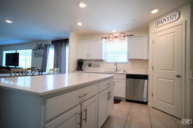 a living room with furniture and a wall painting