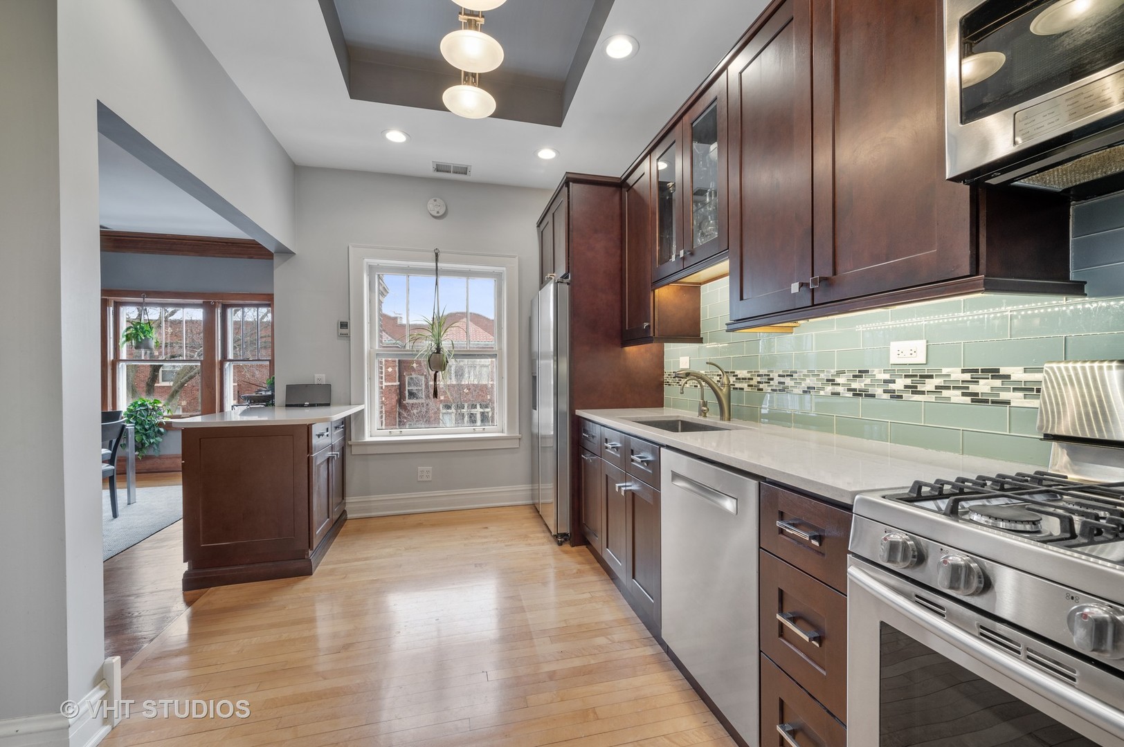 815 Ridge Avenue, Unit 3 Evanston, IL 60202 - Photo 6 of 16 a large kitchen with stainless steel appliances granite countertop a stove and a refrigerator