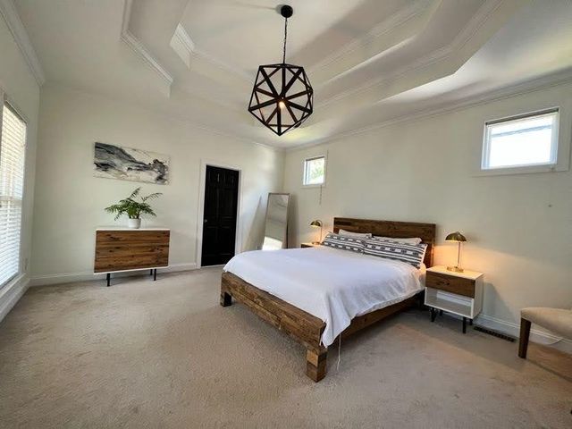 a bedroom with a bed and a chandelier