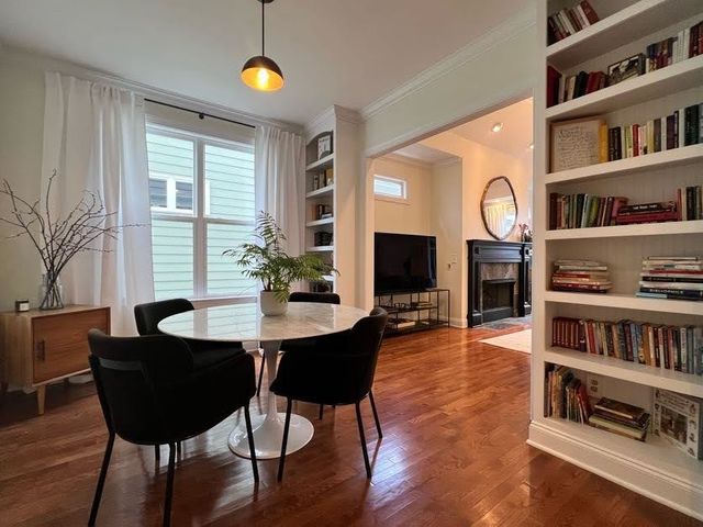 a view of a livingroom with furniture window and wooden floor
