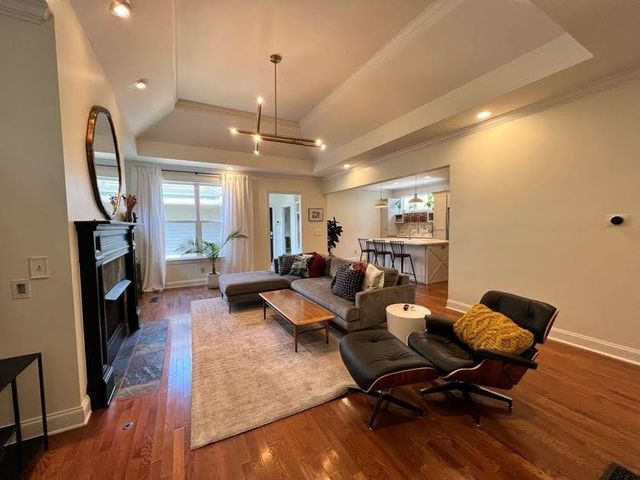 a living room with furniture or wooden floor and a chandelier