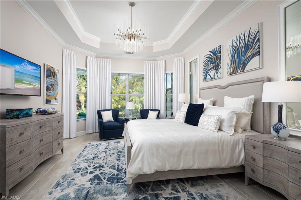 14627 Nicholas Way Naples, FL 34109 - Photo 12 of 27 a bedroom with a large bed and a chandelier