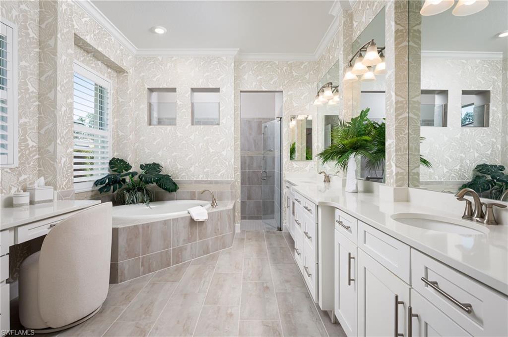 14627 Nicholas Way Naples, FL 34109 - Photo 13 of 27 a spacious bathroom with a double vanity sink a large mirror and shower