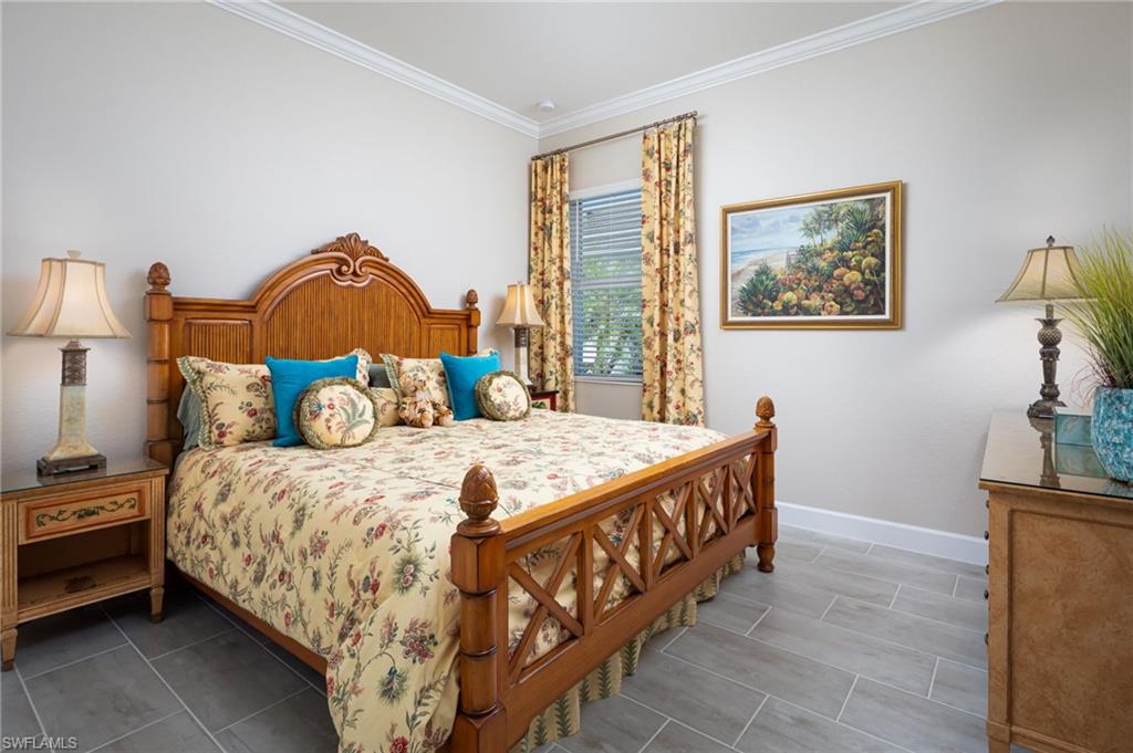 14627 Nicholas Way Naples, FL 34109 - Photo 14 of 27 a bedroom with a bed and a painting on the wall