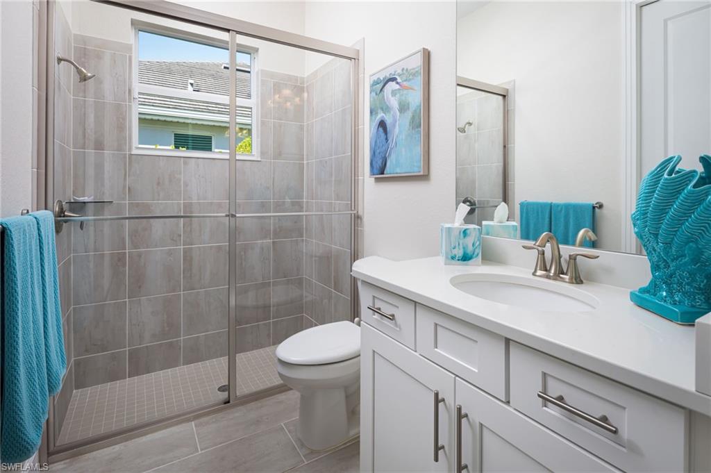 14627 Nicholas Way Naples, FL 34109 - Photo 15 of 27 a bathroom with a sink a toilet and shower