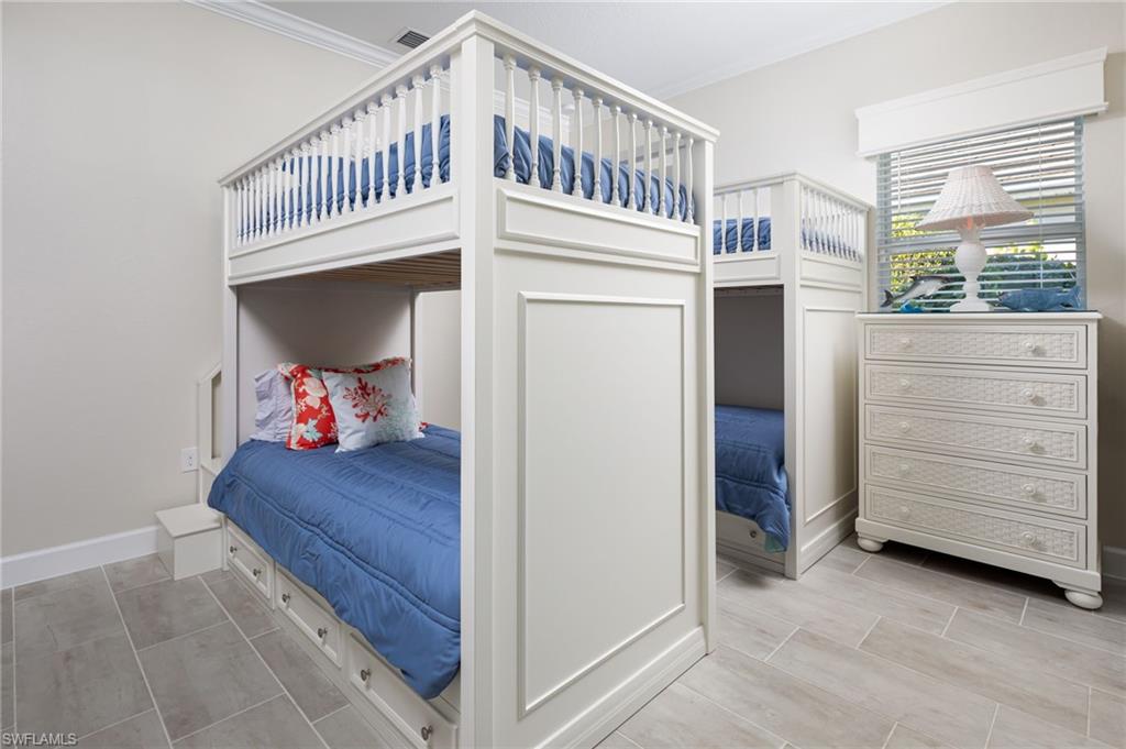 14627 Nicholas Way Naples, FL 34109 - Photo 16 of 27 a view of a bedroom with baby crib and a window