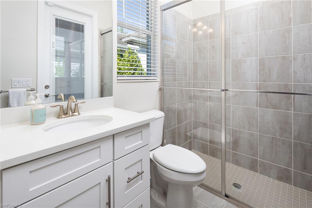 14627 Nicholas Way Naples, FL 34109 - Photo 17 of 27 a bathroom with a sink a toilet and shower