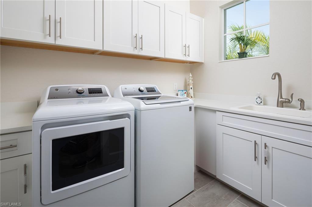 14627 Nicholas Way Naples, FL 34109 - Photo 19 of 27 a kitchen with cabinets appliances and a sink