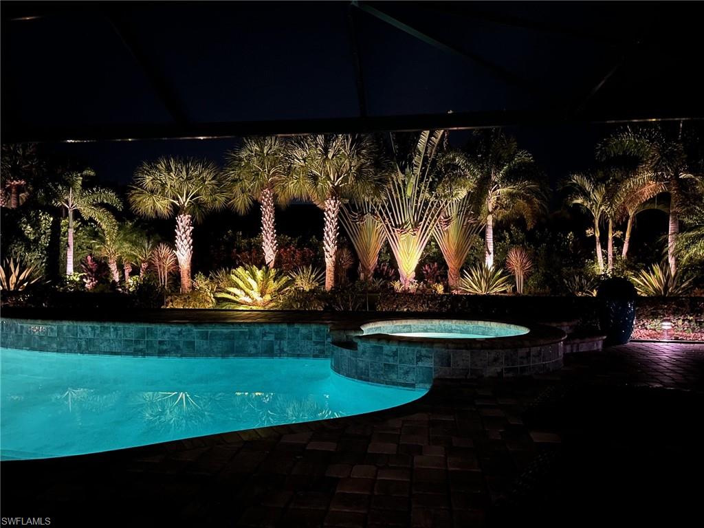 14627 Nicholas Way Naples, FL 34109 - Photo 2 of 27 a view of a swimming pool with an outdoor seating and a yard