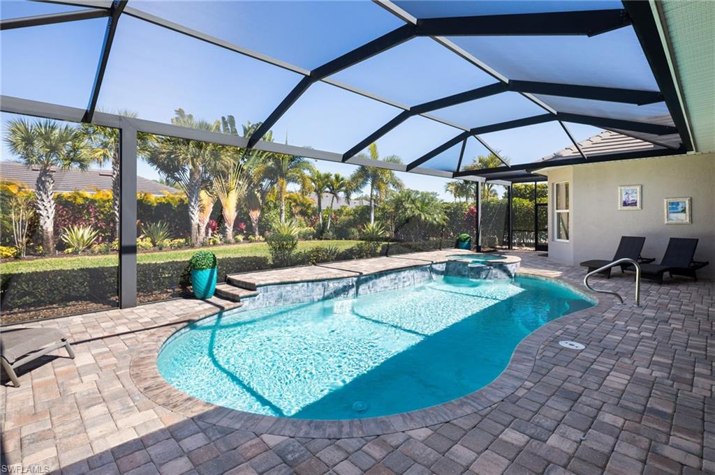 14627 Nicholas Way Naples, FL 34109 - Photo 23 of 27 a view of a patio with a table and chairs under an umbrella