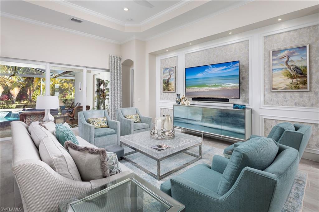14627 Nicholas Way Naples, FL 34109 - Photo 4 of 27 a living room with furniture and a flat screen tv