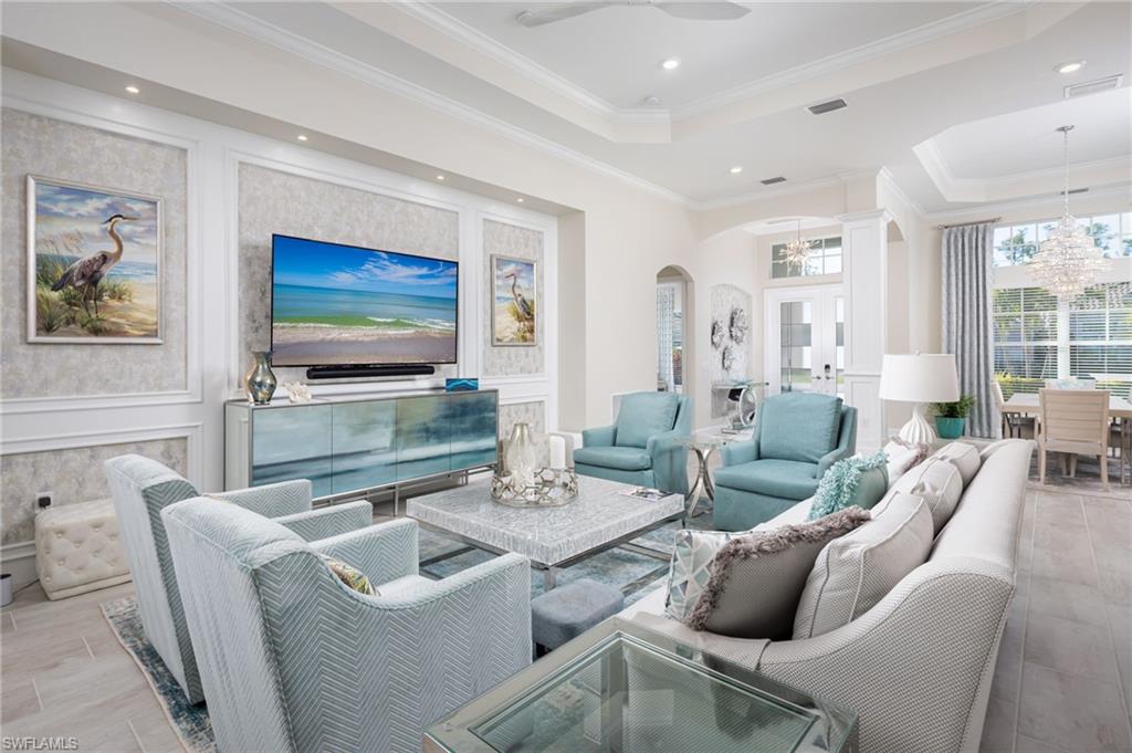 14627 Nicholas Way Naples, FL 34109 - Photo 5 of 27 a living room with furniture and a flat screen tv