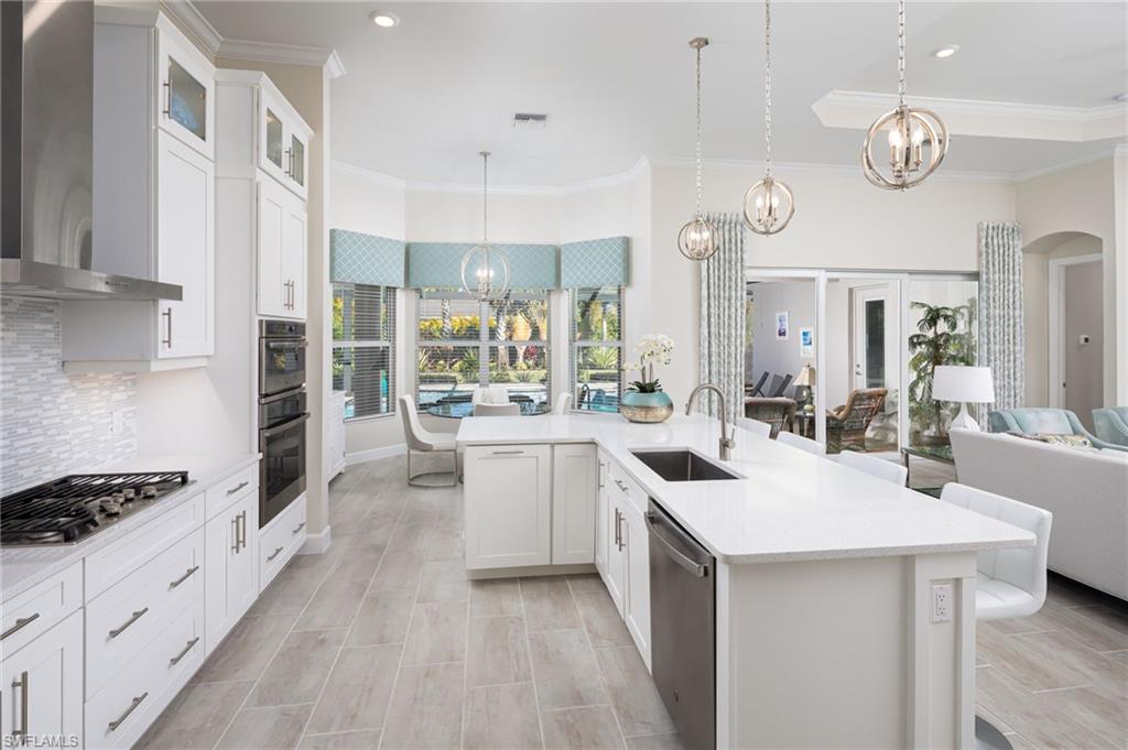 14627 Nicholas Way Naples, FL 34109 - Photo 8 of 27 a kitchen with a sink stove and cabinets