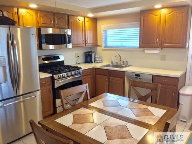 53 Albemarle Road Colonia, NJ 07067 - Photo 2 of 25 a kitchen with stainless steel appliances kitchen island granite countertop a sink stove and refrigerator