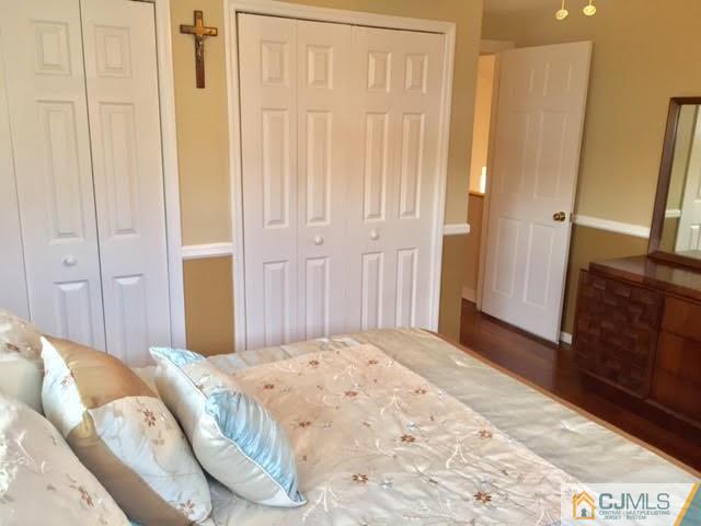 53 Albemarle Road Colonia, NJ 07067 - Photo 5 of 25 a bedroom with a bed and a mirror
