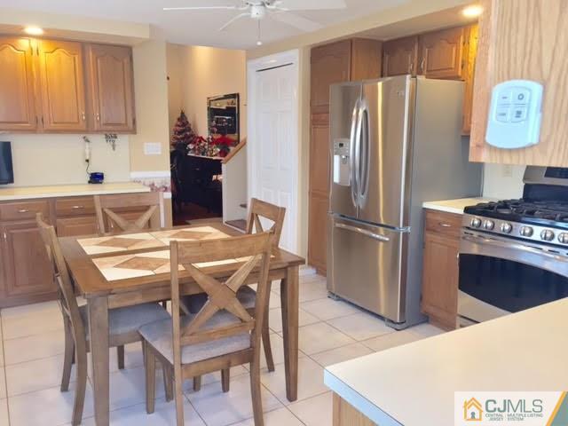 53 Albemarle Road Colonia, NJ 07067 - Photo 9 of 25 a kitchen with stainless steel appliances a refrigerator a stove a sink and chairs