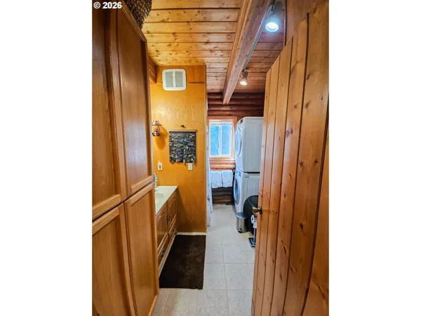 a view of a hallway with a white door and a glass window