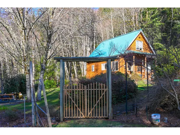 a backyard of a house with wooden floor and fence