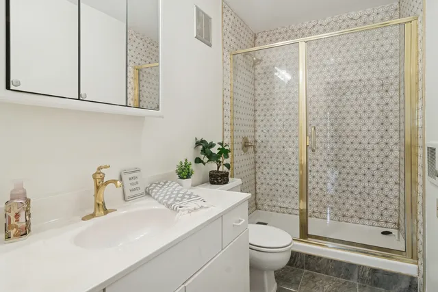 a bathroom with a sink toilet and shower