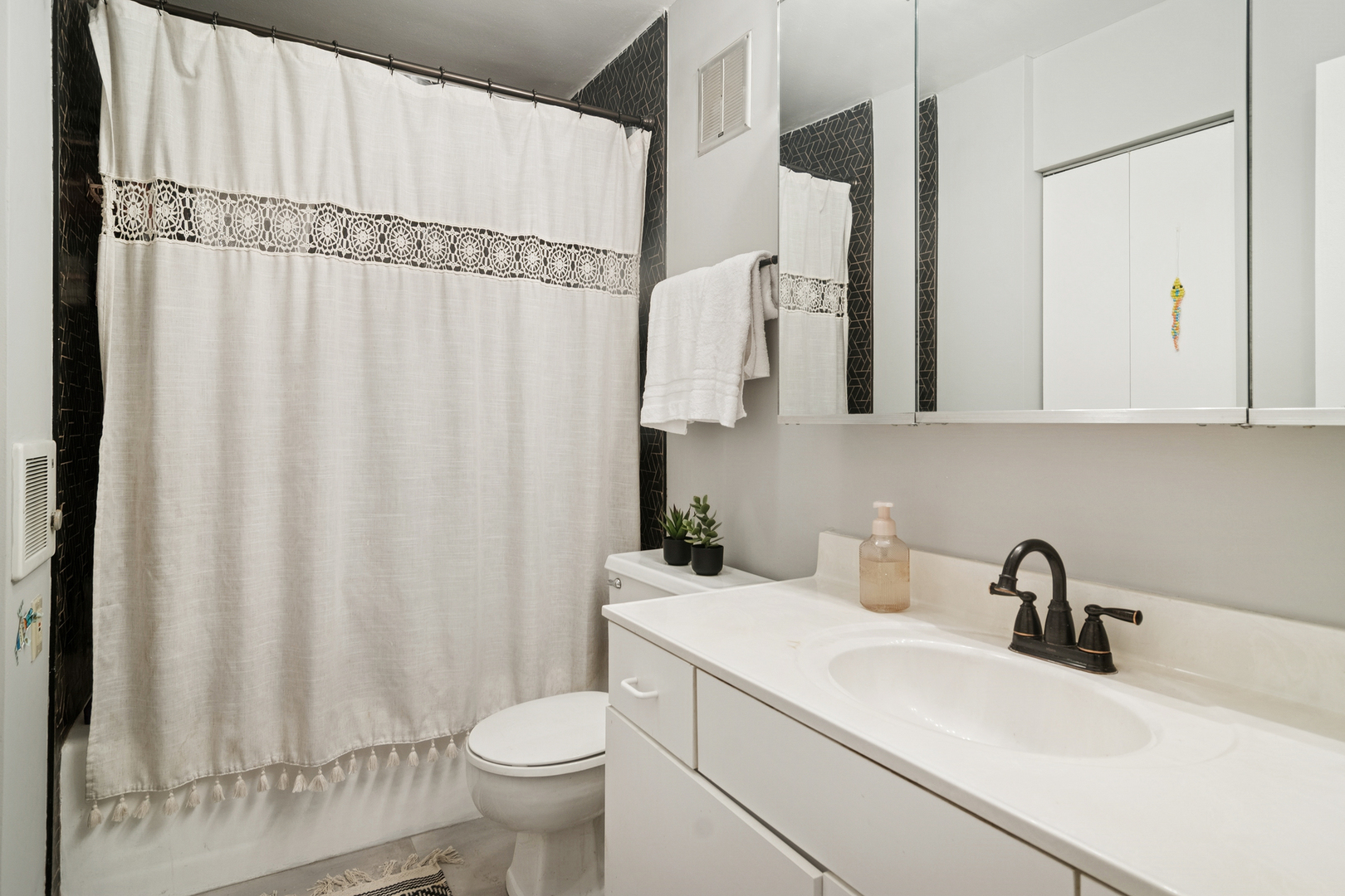 1415 East Central Road, Unit 422C Arlington Heights, IL 60005 - Photo 15 of 19 a bathroom with a sink a toilet and a mirror