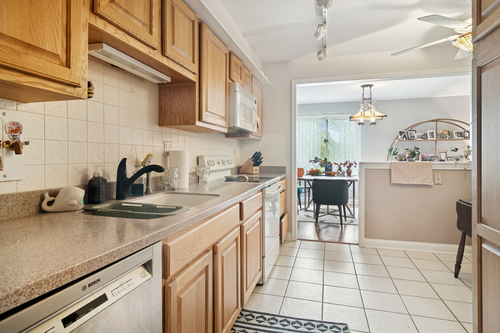 1415 East Central Road, Unit 422C Arlington Heights, IL 60005 - Photo 5 of 19 a kitchen with a sink a stove and cabinets