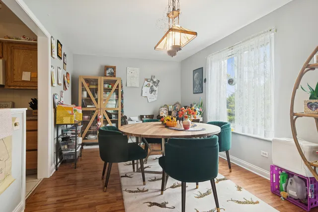 a view of a dining room with furniture a chandelier and wooden floor