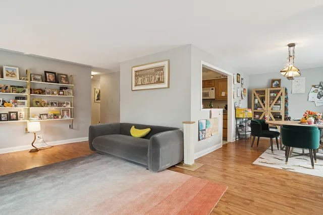 a living room with furniture a dining table and a piano