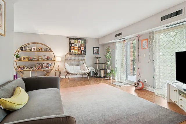 a living room with furniture a flat screen tv and a large window