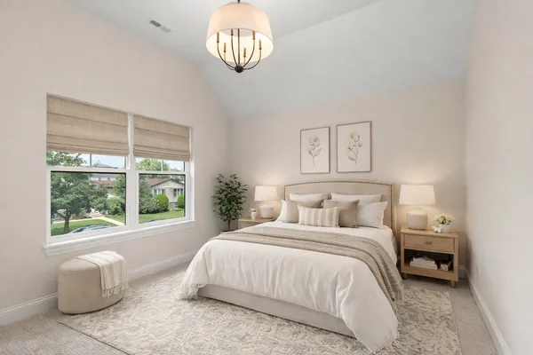 a bedroom with a large bed and a large window