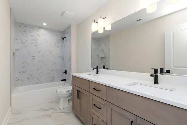 a bathroom with a tub sink and mirror