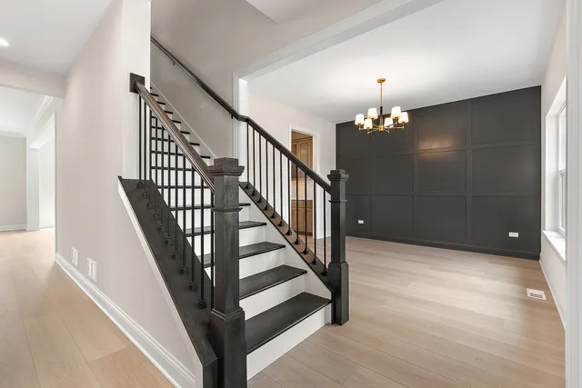 a view of entryway and hall with wooden floor