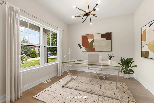 a living room with a large window and a table