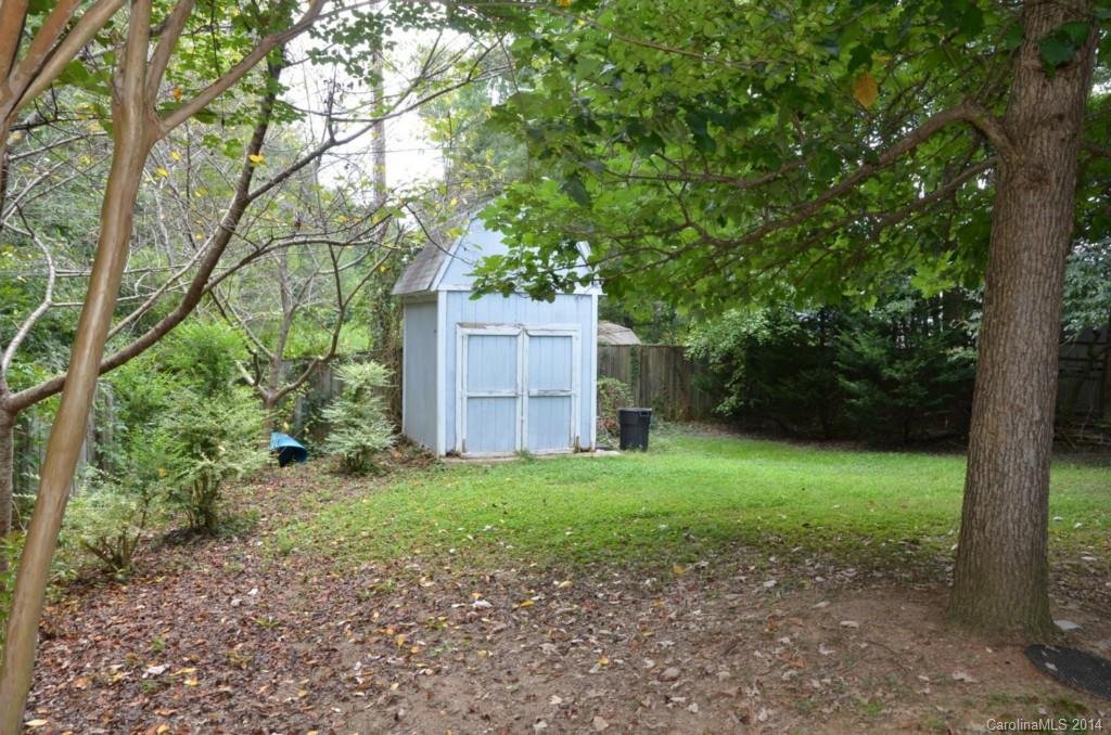 1932 Misty Vale Road Charlotte, NC 28214 - Photo 11 of 13 a view of a house with a yard and large trees
