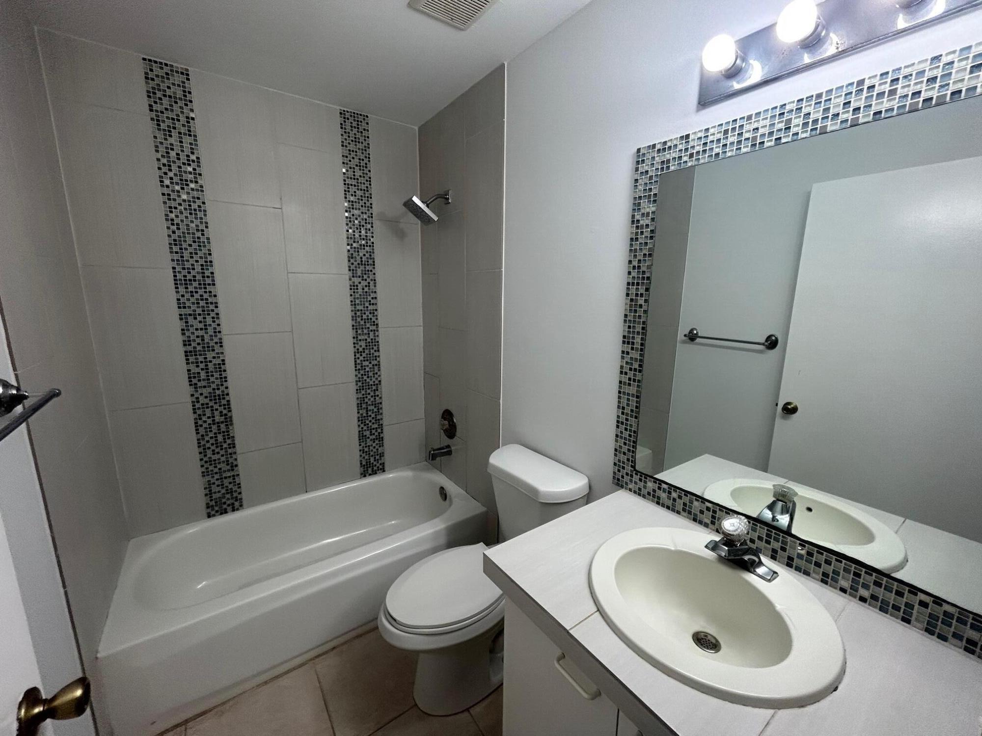 10136 Boynton Pl Circle Boynton Beach, FL 33437 - Photo 11 of 12 a bathroom with a sink toilet and shower