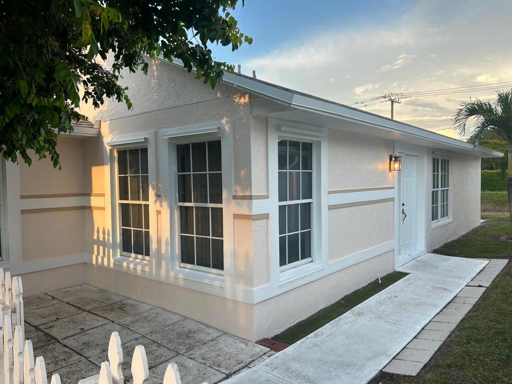 10136 Boynton Pl Circle Boynton Beach, FL 33437 - Photo 2 of 12 a house with a glass door