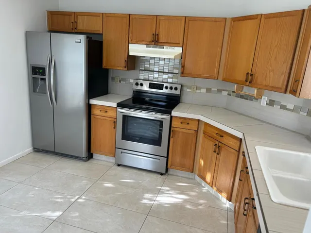 a kitchen with a refrigerator and a sink
