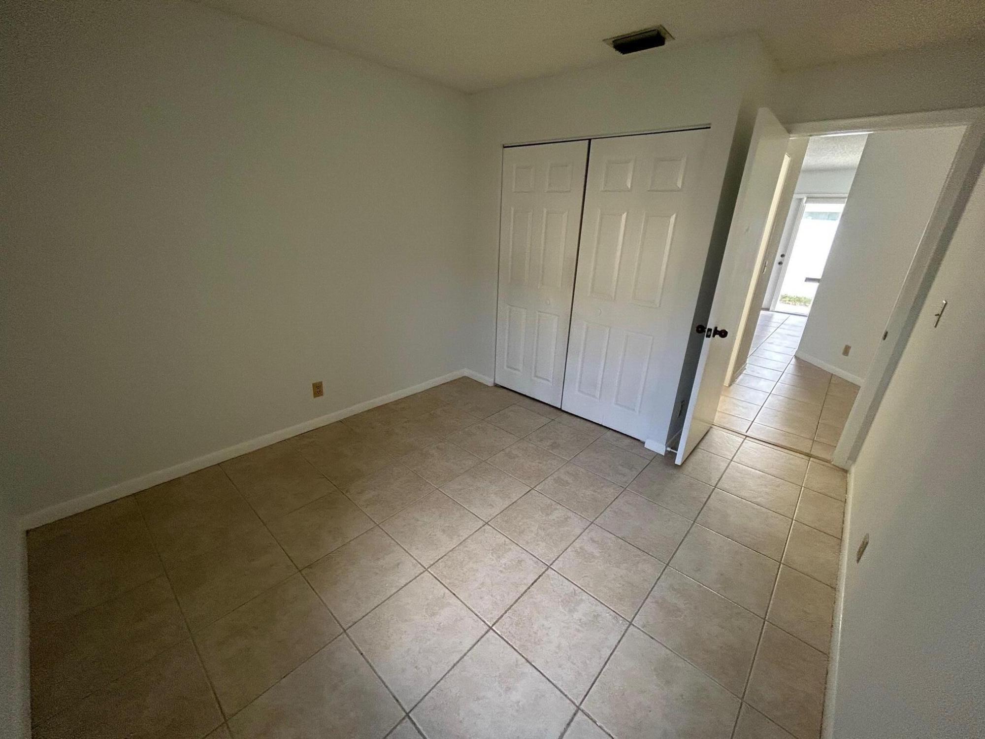10136 Boynton Pl Circle Boynton Beach, FL 33437 - Photo 9 of 12 an empty room with a door