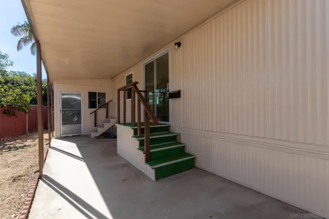 a view of a house with backyard and potted plants