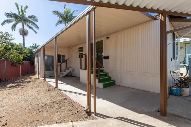 a view of a house with backyard and sitting area