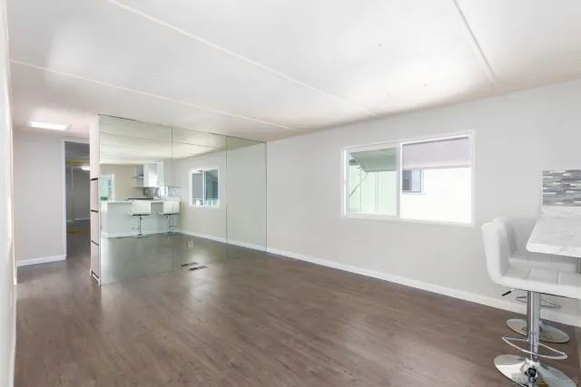 a view of a livingroom with furniture wooden floor and a window