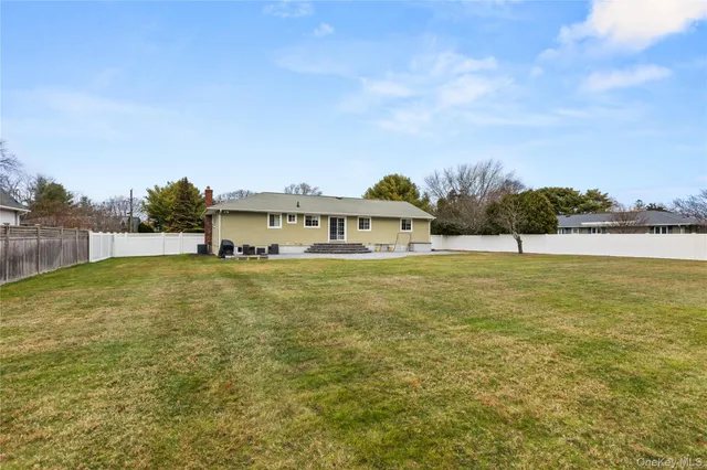 a view of a big yard with a large trees
