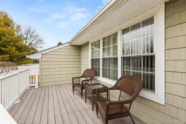 a view of a two chairs in the balcony