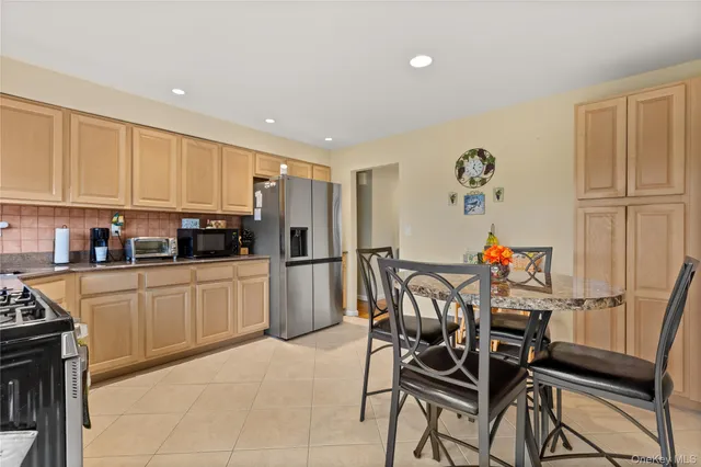 a kitchen with stainless steel appliances granite countertop a refrigerator and microwave