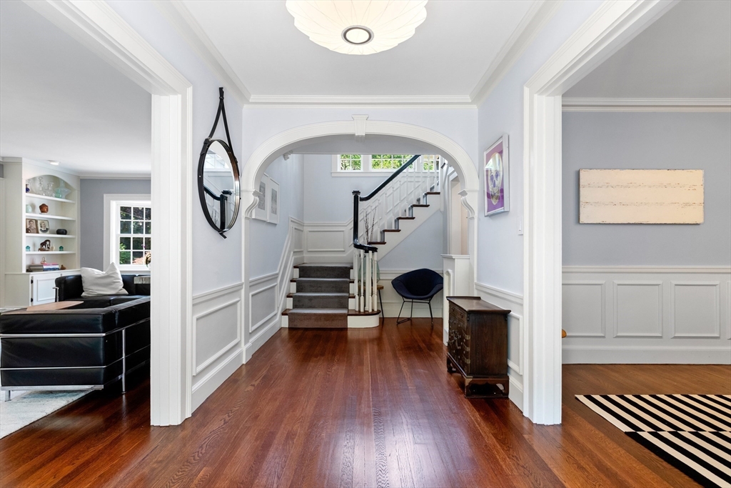 a view of living room and workspace with wooden floor