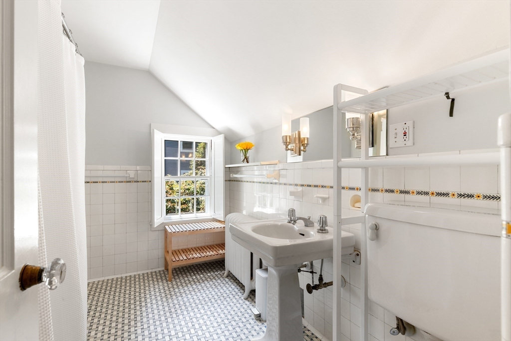 17 Swan Road Winchester, MA 01890 - Photo 23 of 41 a bathroom with a sink a mirror and a shower