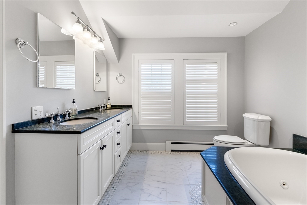 17 Swan Road Winchester, MA 01890 - Photo 26 of 41 a spacious bathroom with a granite countertop sink and a bathtub