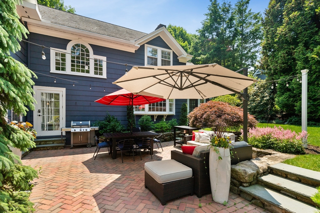 17 Swan Road Winchester, MA 01890 - Photo 38 of 41 a view of a patio with a table and chairs under an umbrella